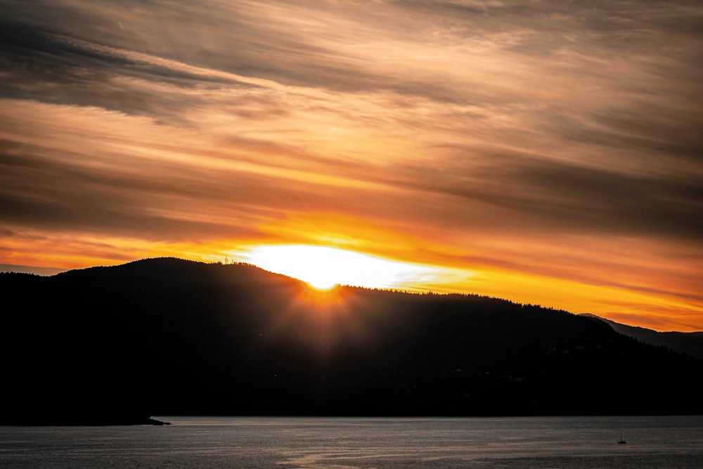 a sunset over a mountain