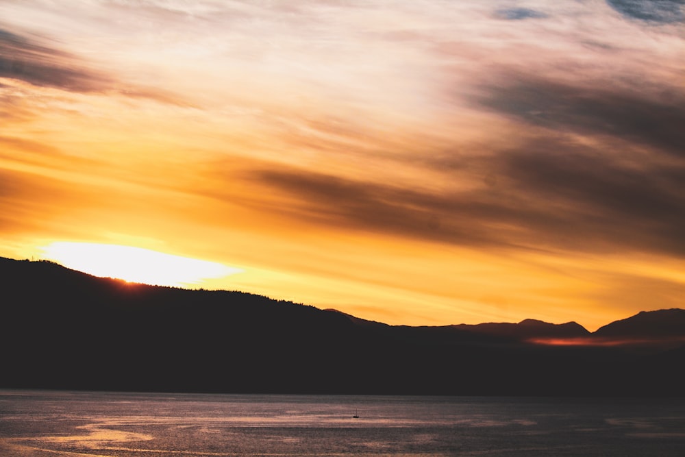 a sunset over a mountain range