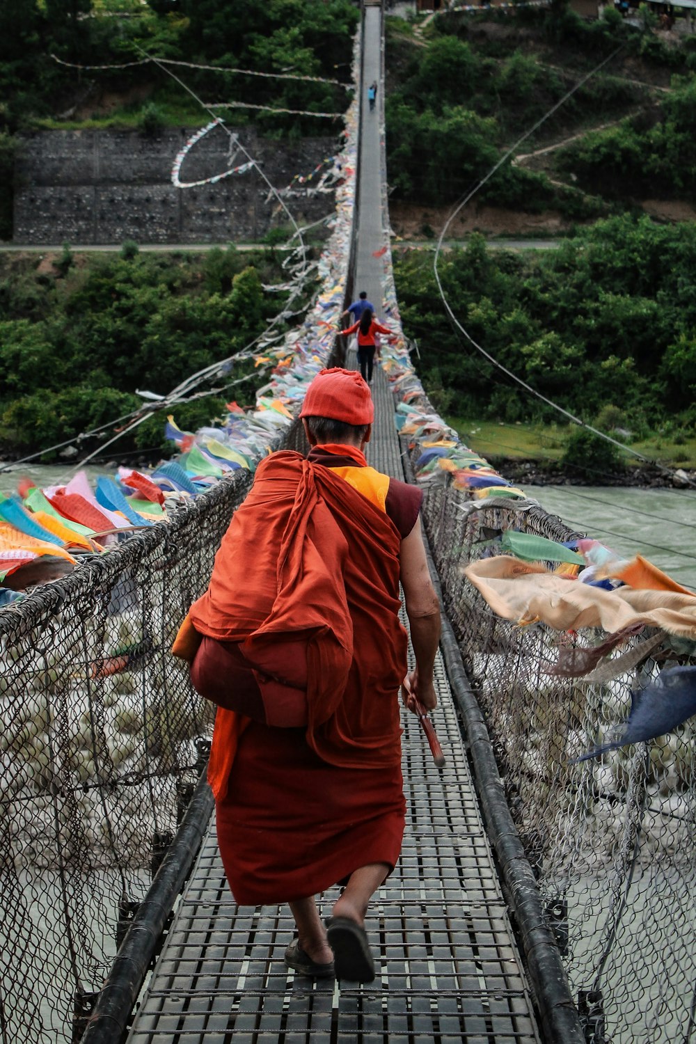 a person walking on a suspension bridge