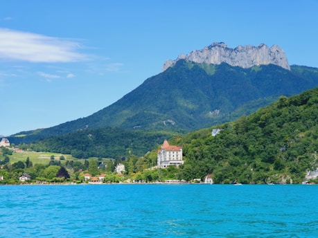 a body of water with a mountain in the background