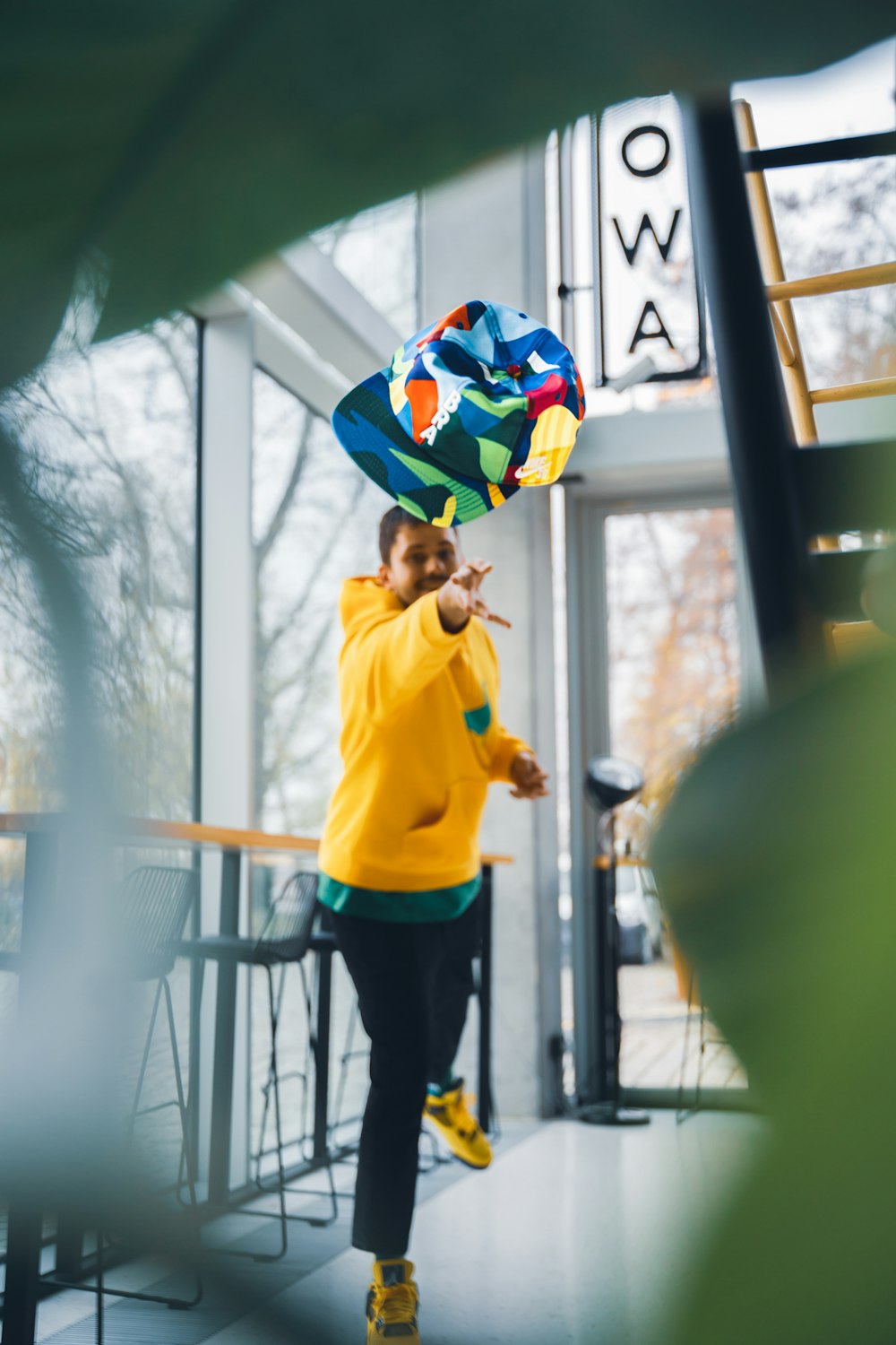 a person holding a rainbow umbrella