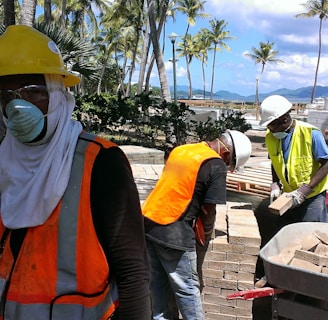a group of people wearing safety vests and masks