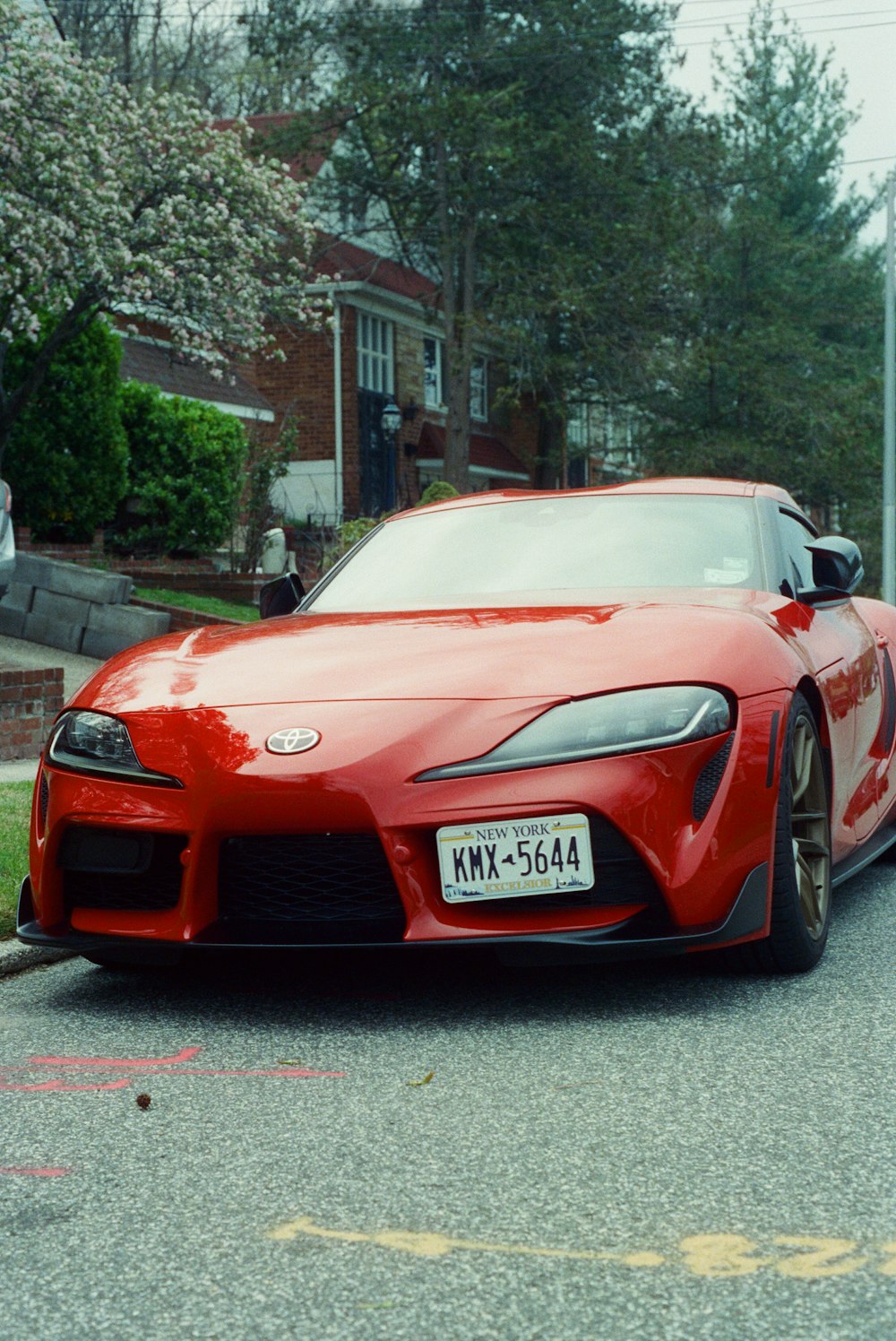 a red car parked on the side of a road