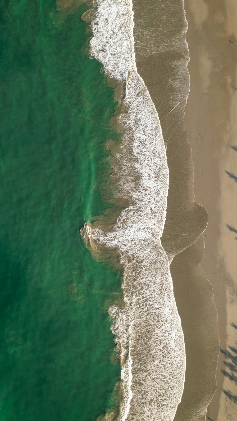 a body of water with a rock in the middle