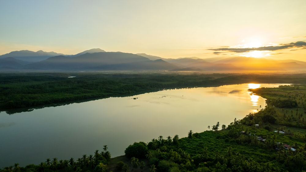 a body of water with trees and hills around it