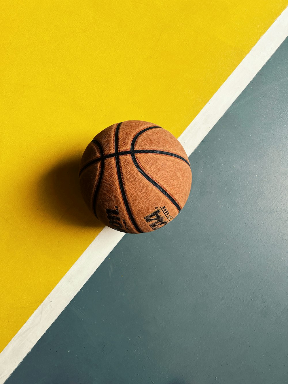 a basketball on a yellow surface