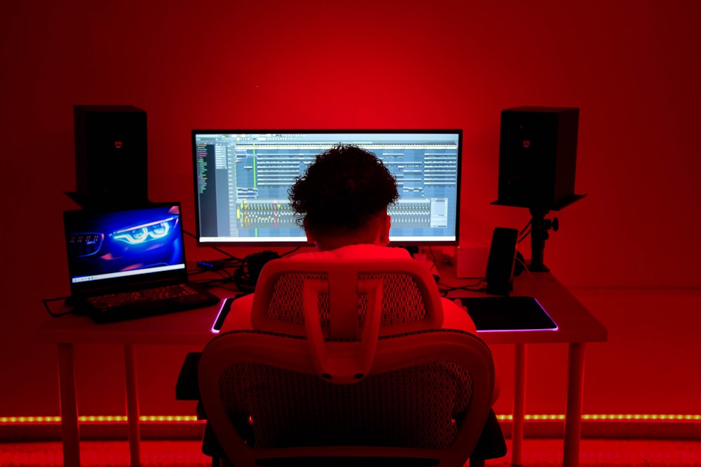 a person sitting in front of a computer