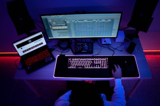 a person sitting at a desk with a computer and a keyboard
