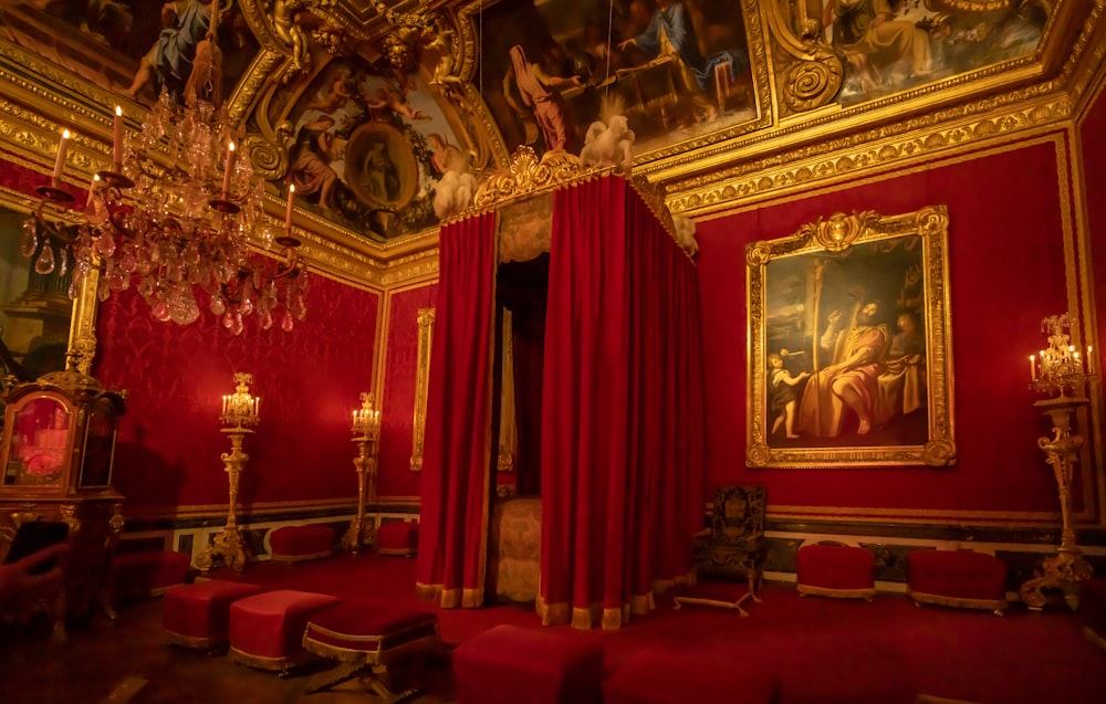 a room with red curtains and a painting on the wall