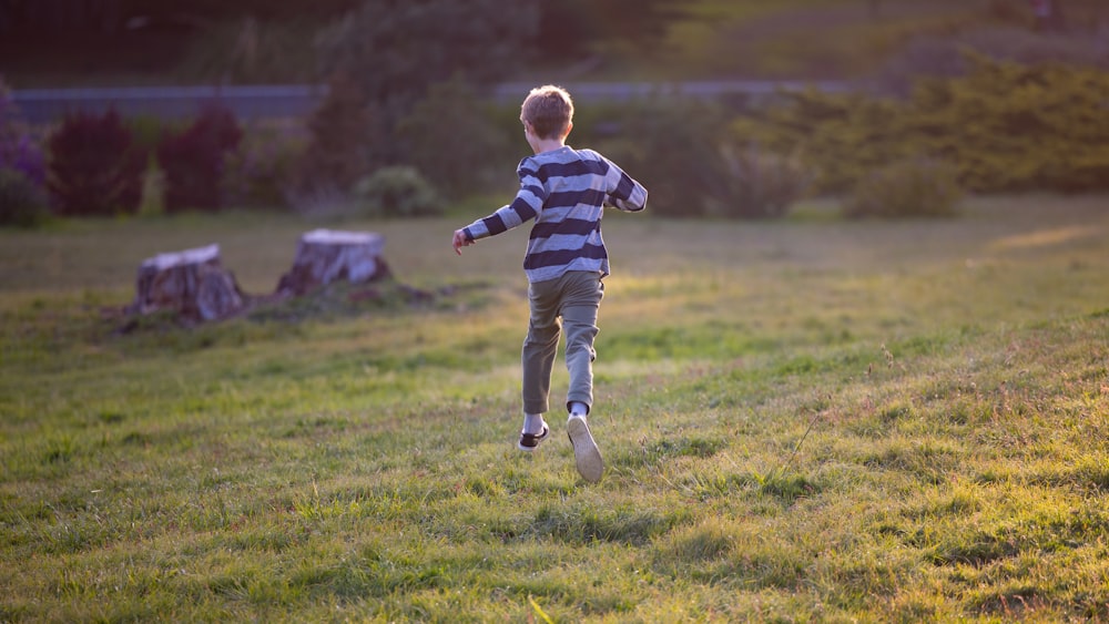 a child running in a grassy area