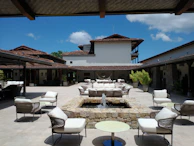 A quaint stone courtyard adorned with vibrant bougainvillea and comfortable seating for relaxing afternoons.