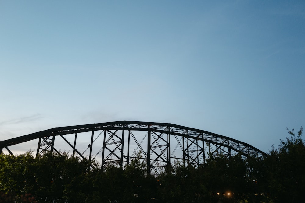 a roller coaster with trees in the background