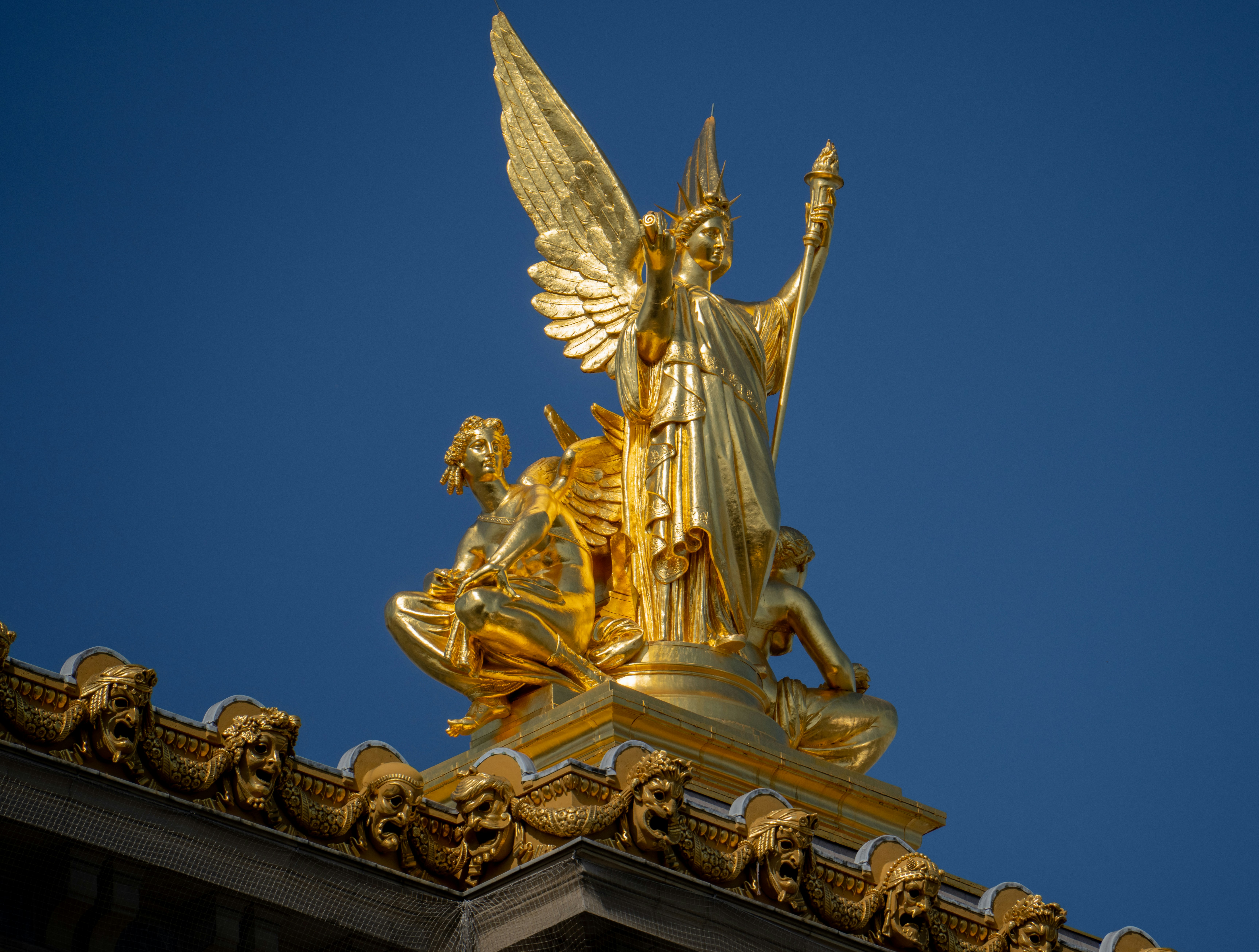 a golden statue on a building
