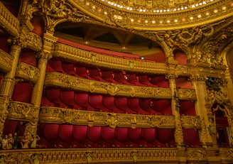 Inside Teatro alla Scala, showcasing its elegant red velvet seats and golden balconies.