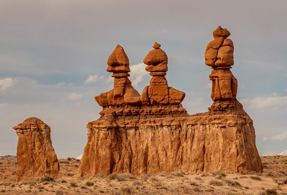 a group of rocks in a desert with Goblin Valley State Park in the background