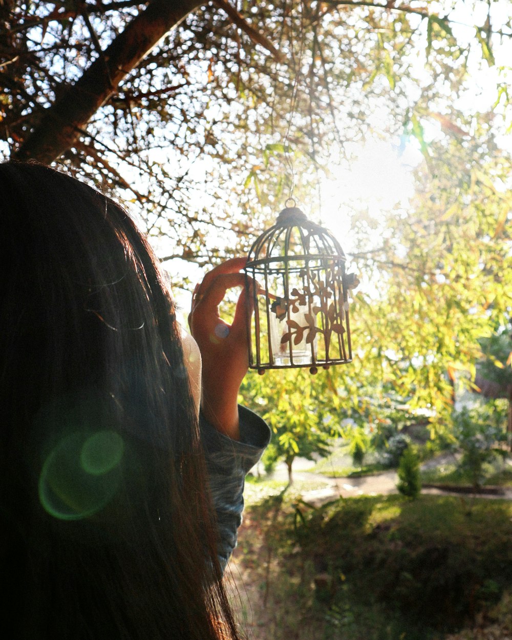 a person holding a bird feeder