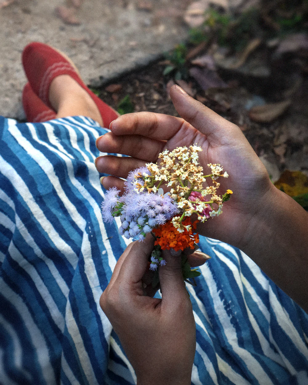 A florist trimming stems at the studio bench
