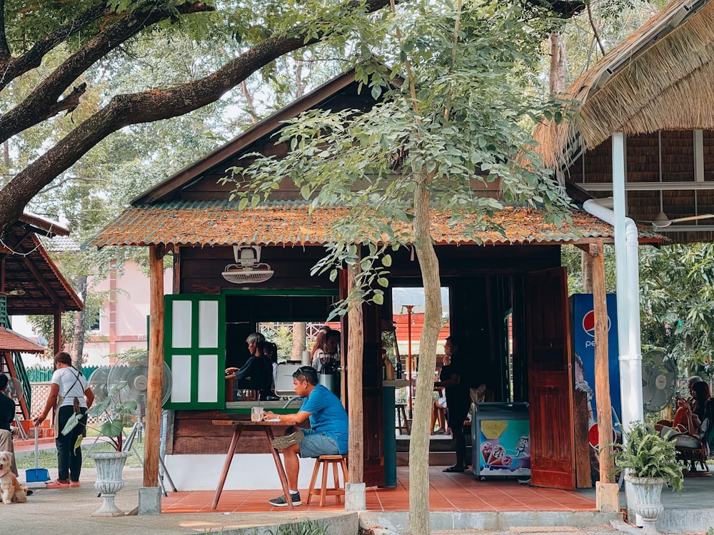 a person sitting at a table outside a building