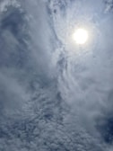 Close-up of a weather app displaying animated sun and clouds.