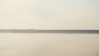 A serene landscape showcasing soft blues and muted golds, reflecting a calm and minimal lifestyle.