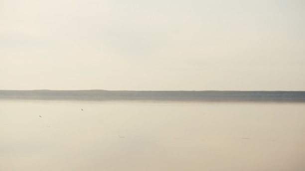 A serene landscape showcasing soft blues and muted golds, reflecting a calm and minimal lifestyle.