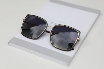 a pair of sunglasses on a white surface