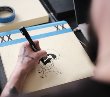 a person drawing on a paper