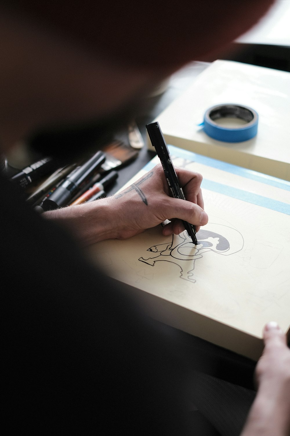 a person drawing on a piece of paper