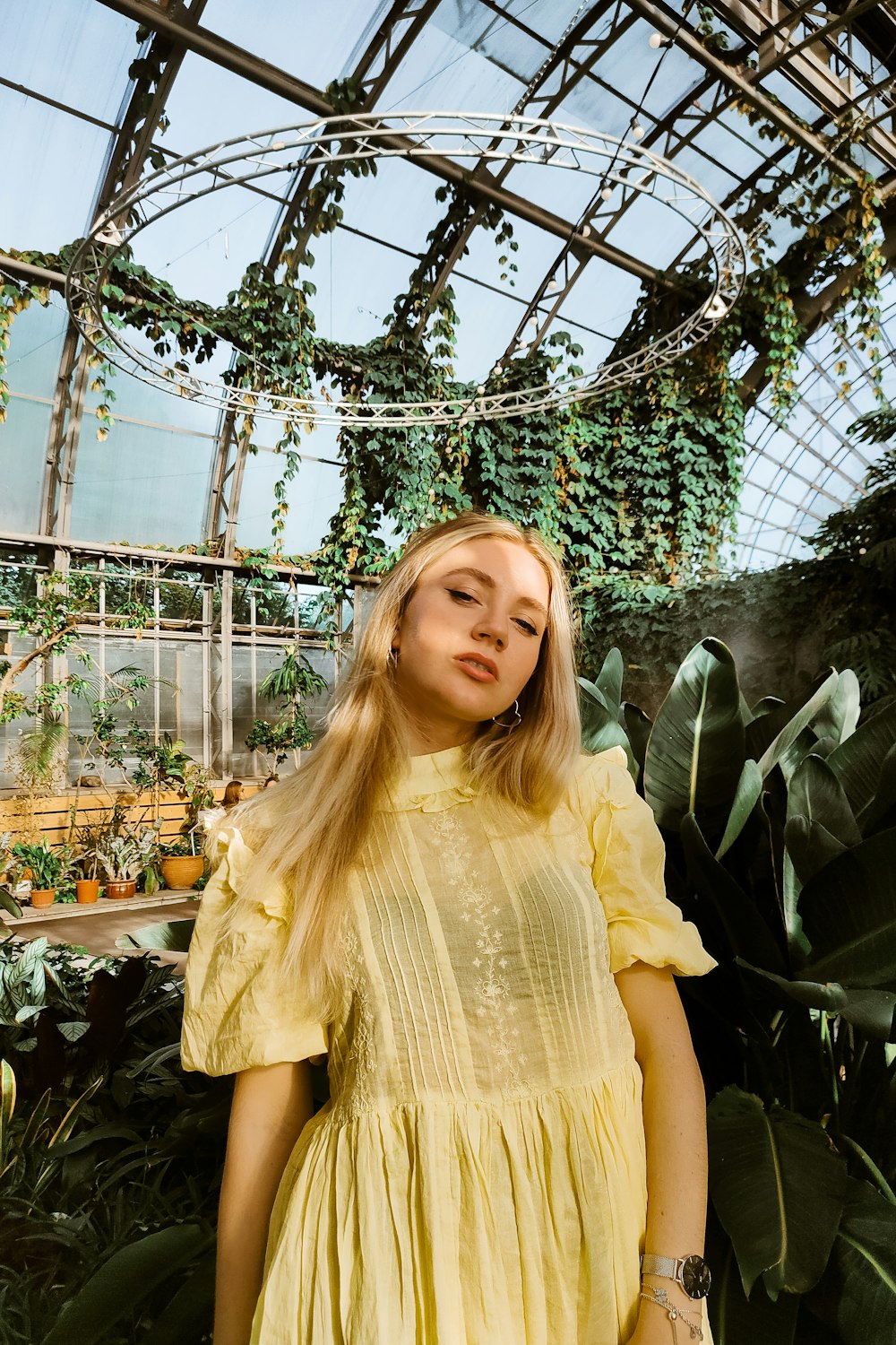 a woman standing in a greenhouse