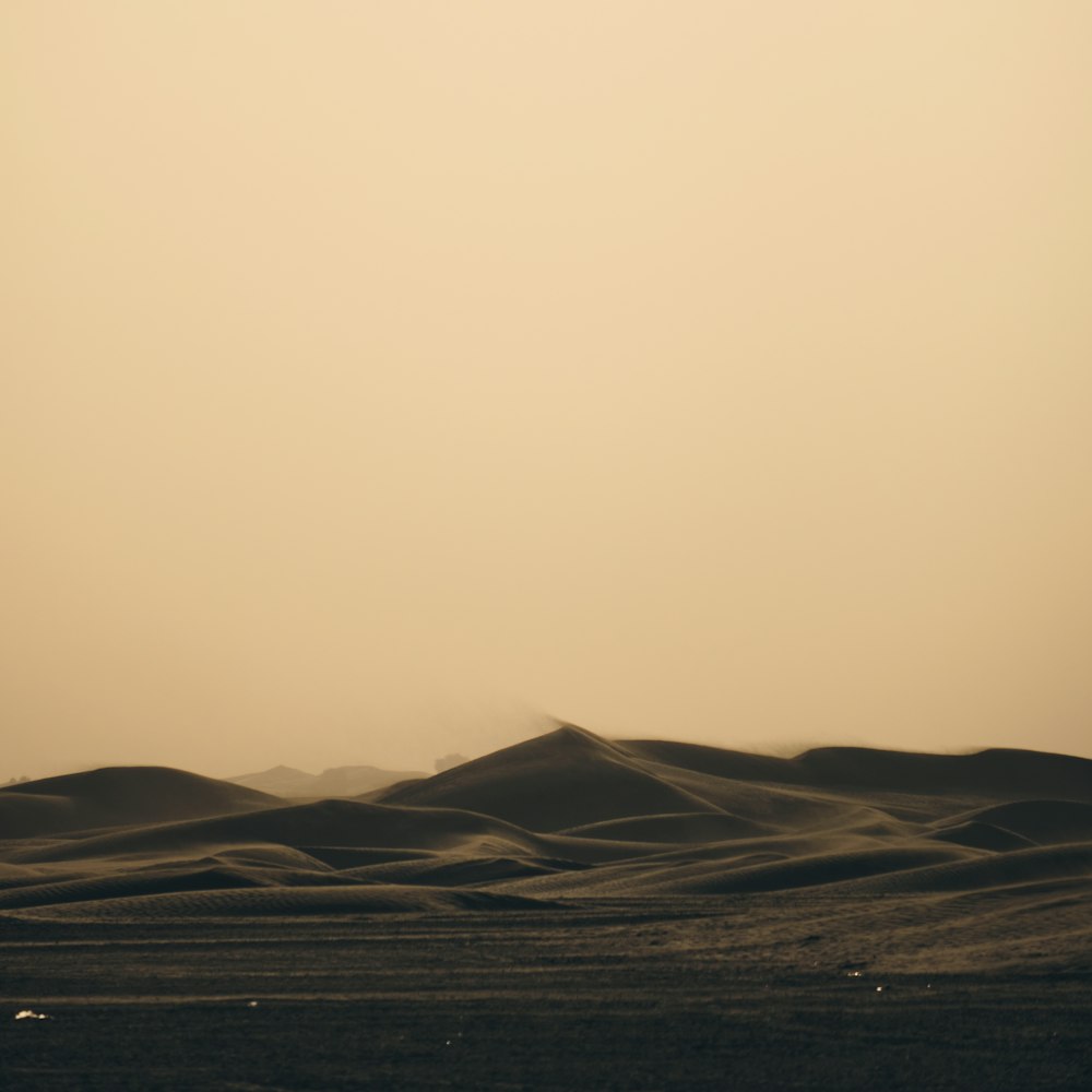 a large flat area with hills in the distance