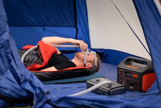 Patient undergoing a sleep apnea test with monitoring equipment attached.