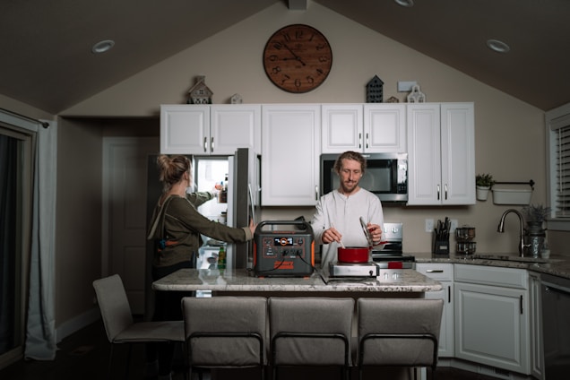 A modern kitchen featuring various household appliances in use.