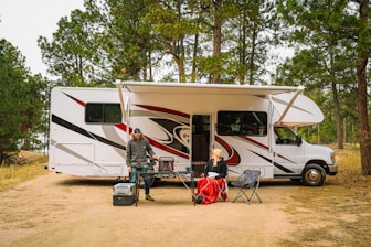 a group of people outside of a camper