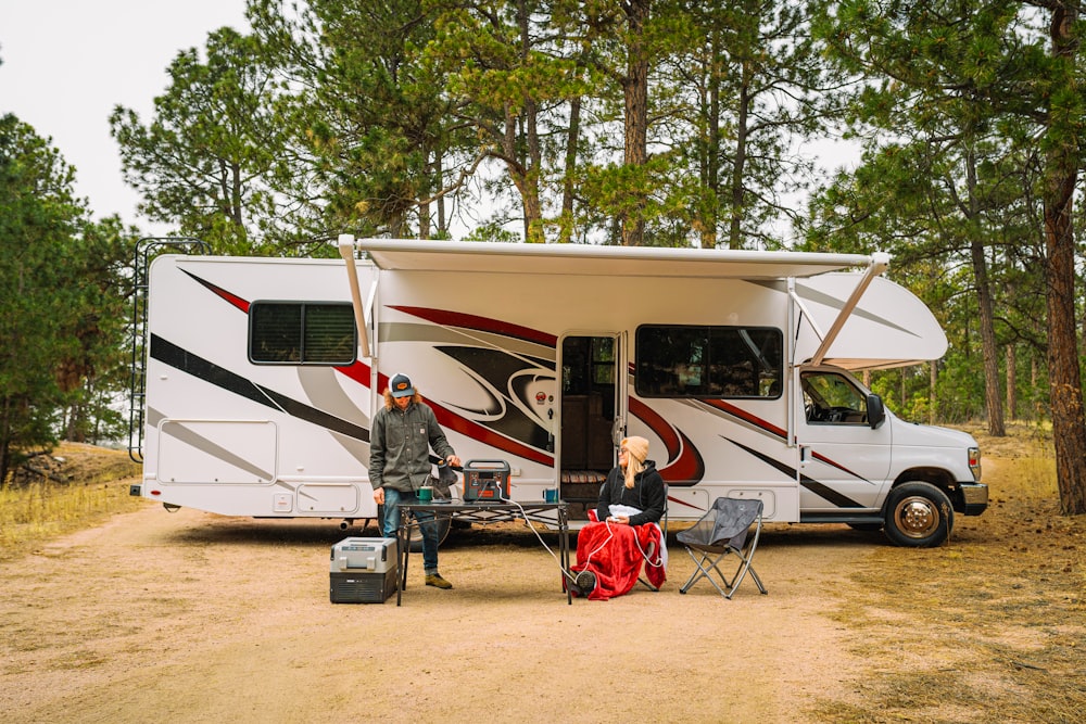 a group of people outside of a camper