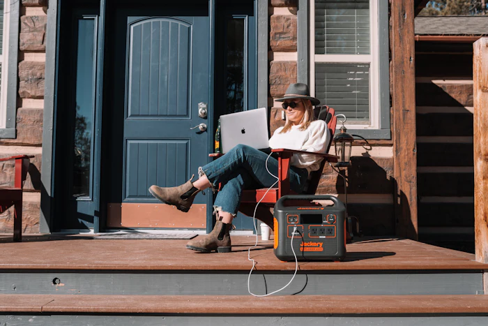 A person working on a laptop powered by a portable battery unit