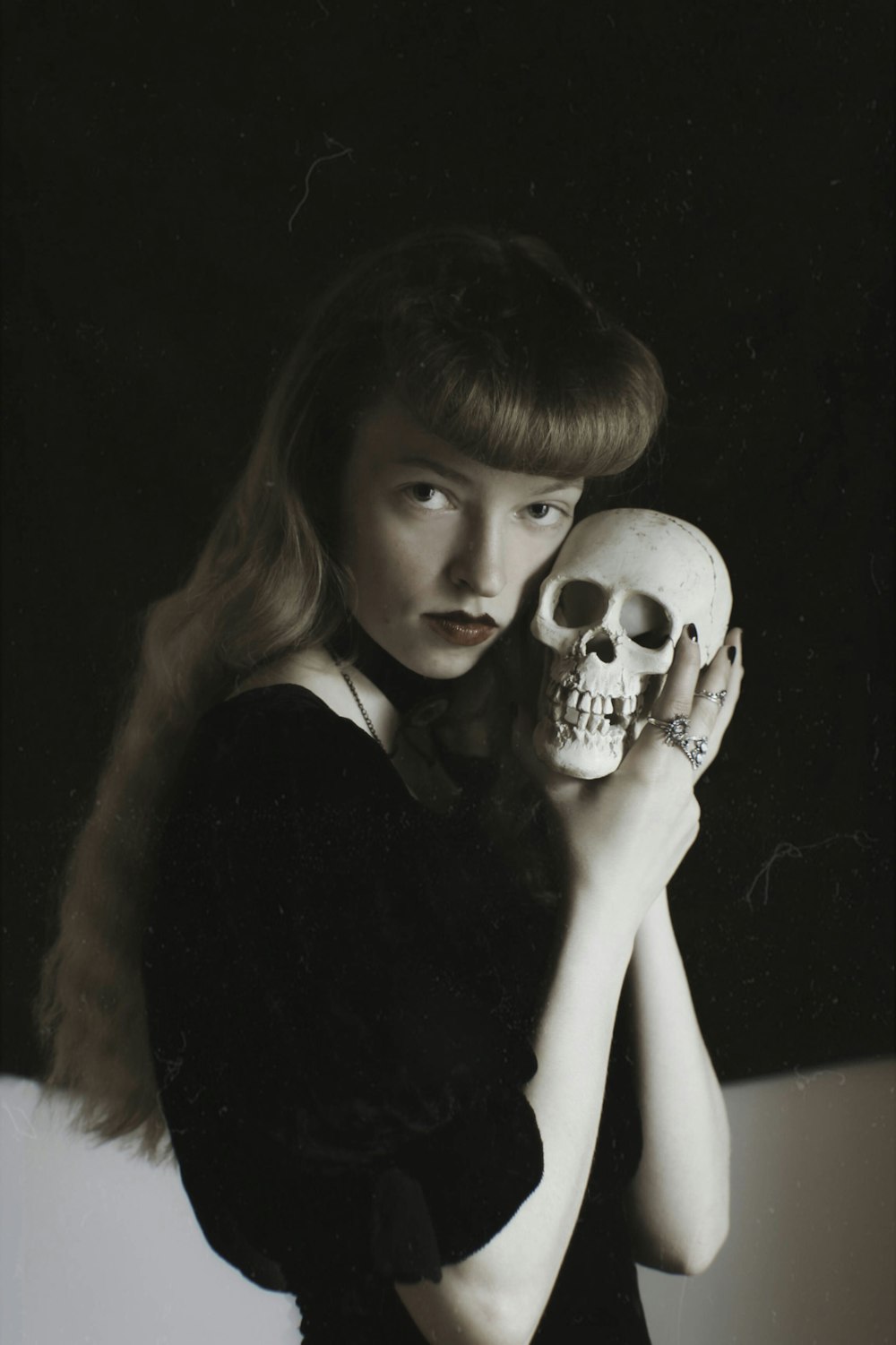 a person holding a skull