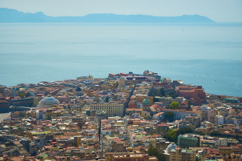 a city with a body of water in the background