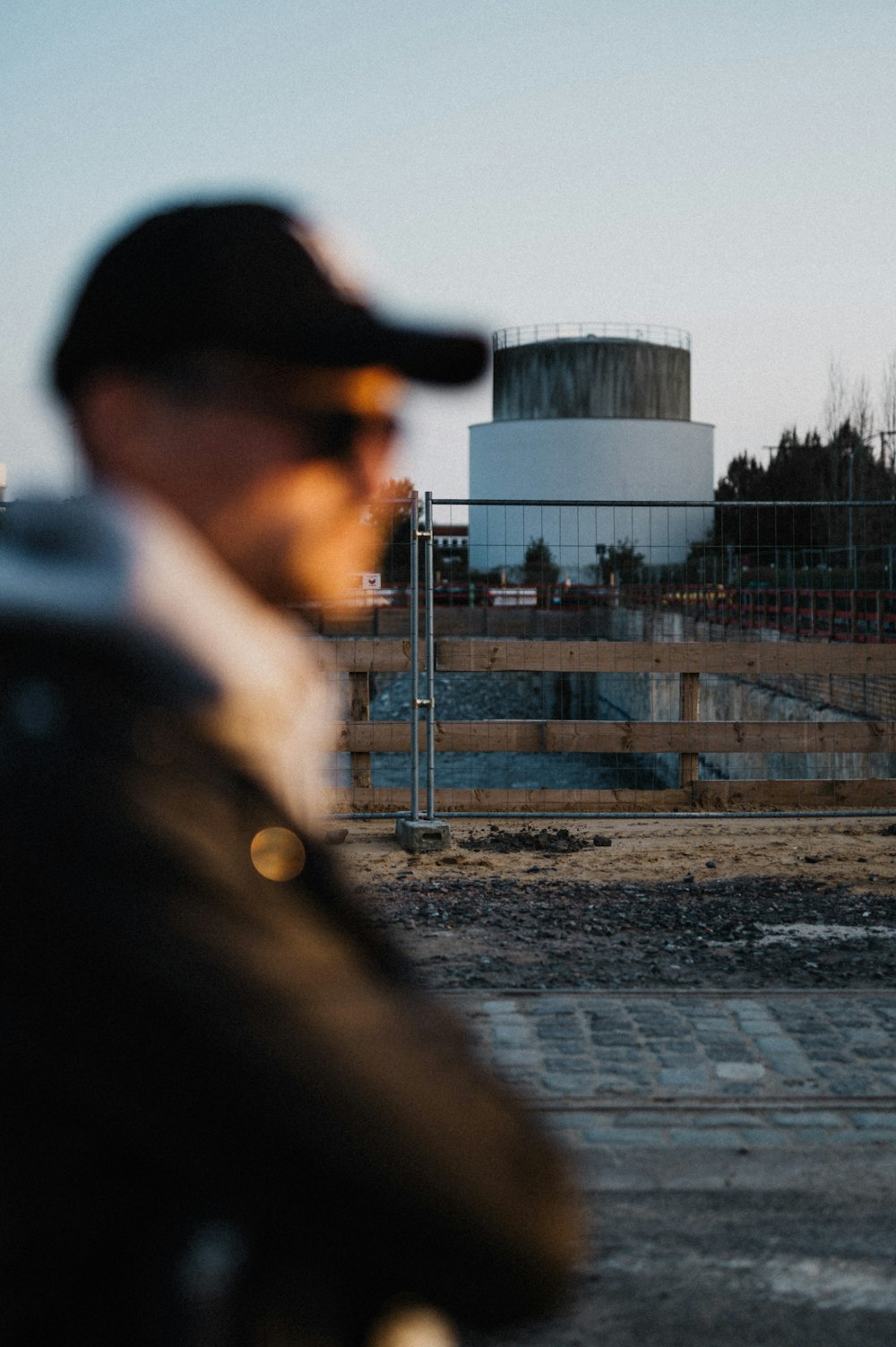 a man looking at a water tower