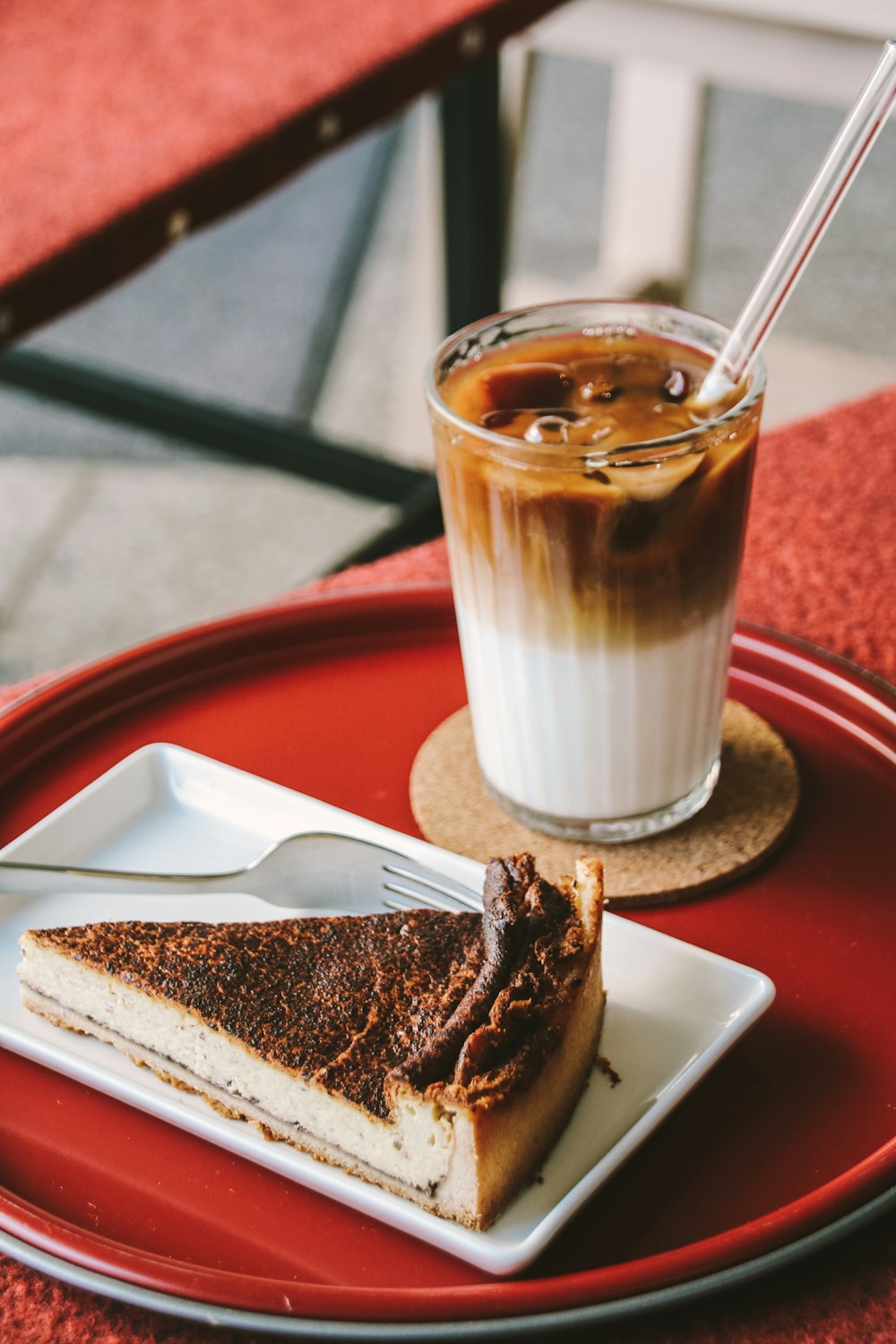 a slice of cake and a drink on a table