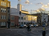 a person riding a bicycle on a street with cars and buildings