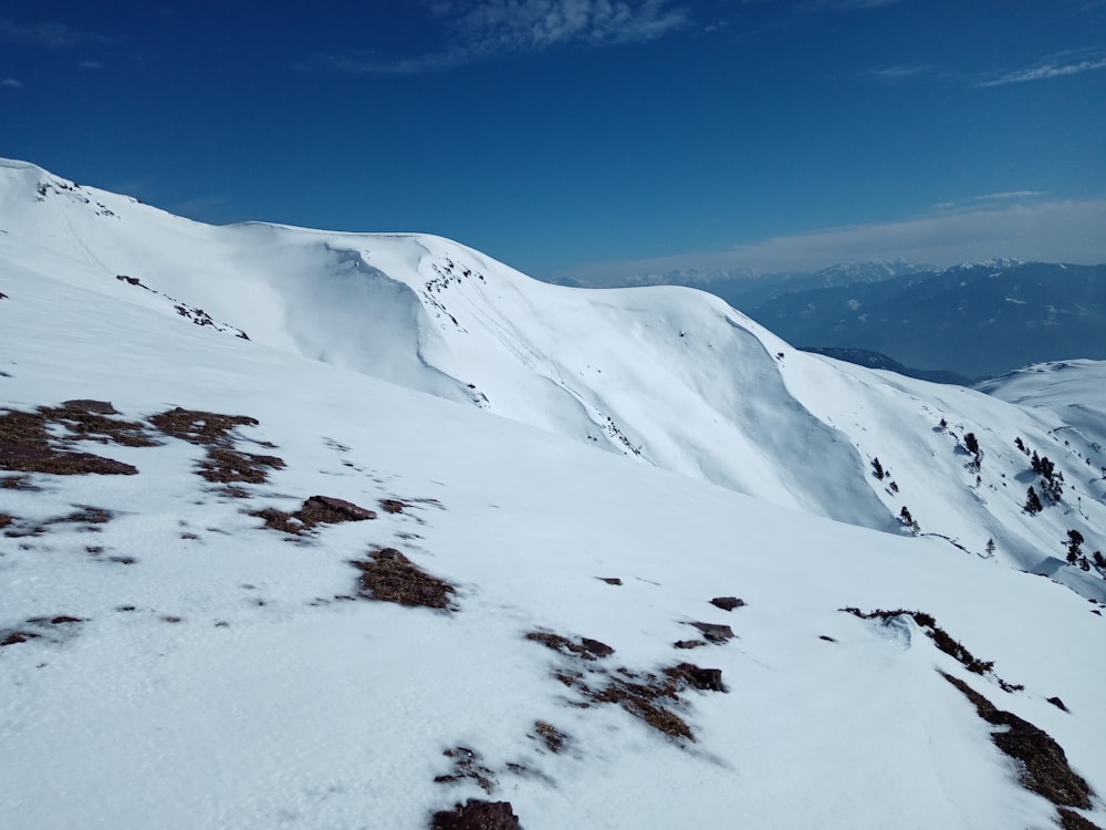 a snowy mountain with blue sky