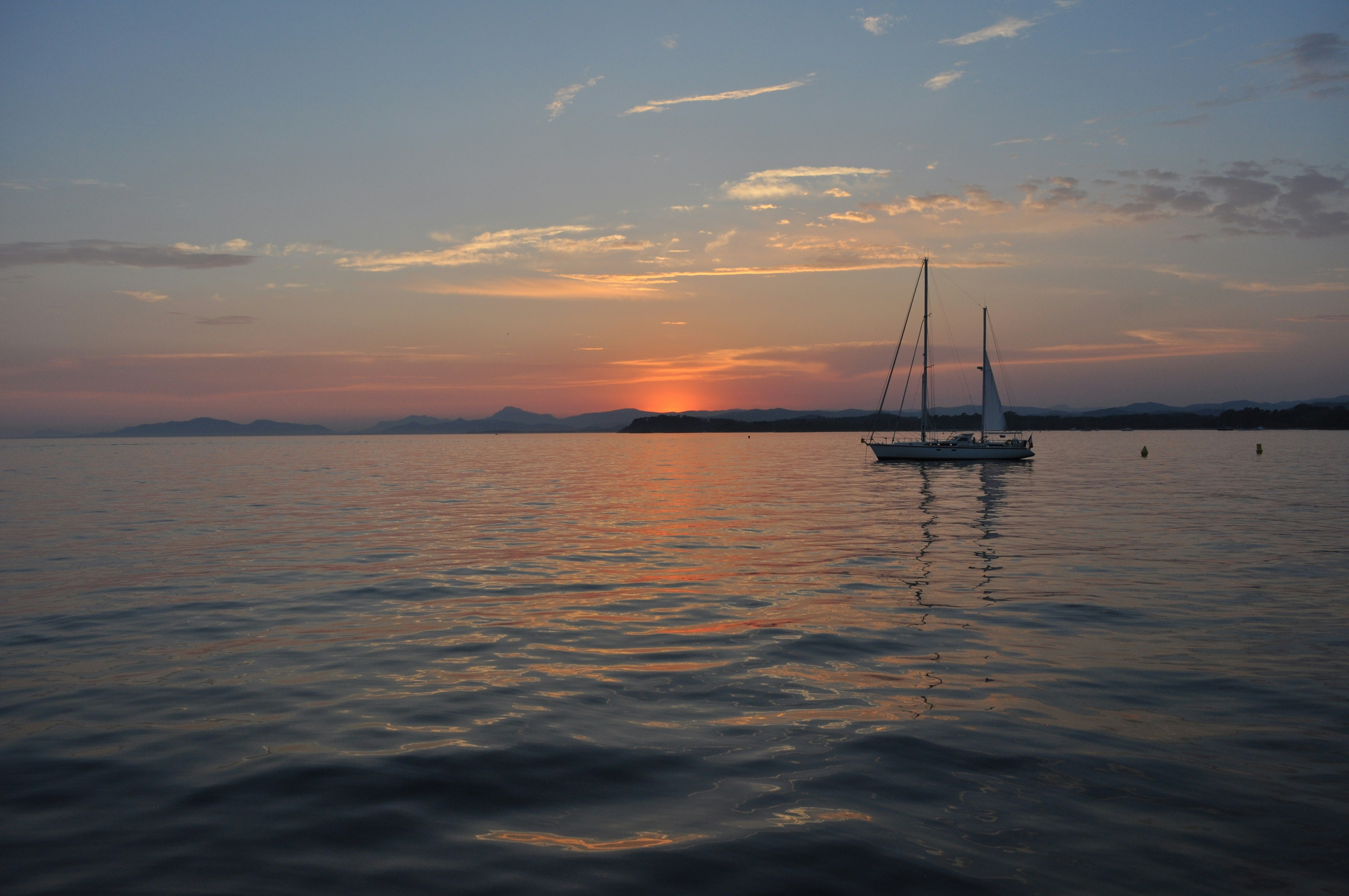 Sailboat on calm sunset water off the Brazilian coast