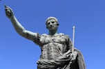 a statue of a person holding a staff