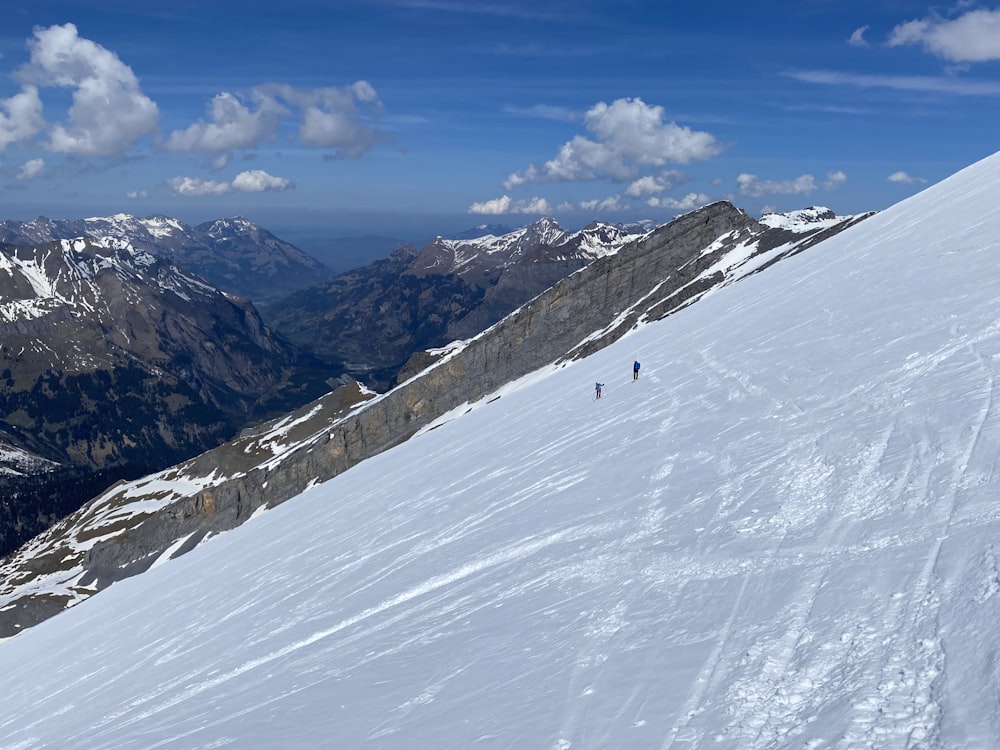 a group of people skiing down a mountain