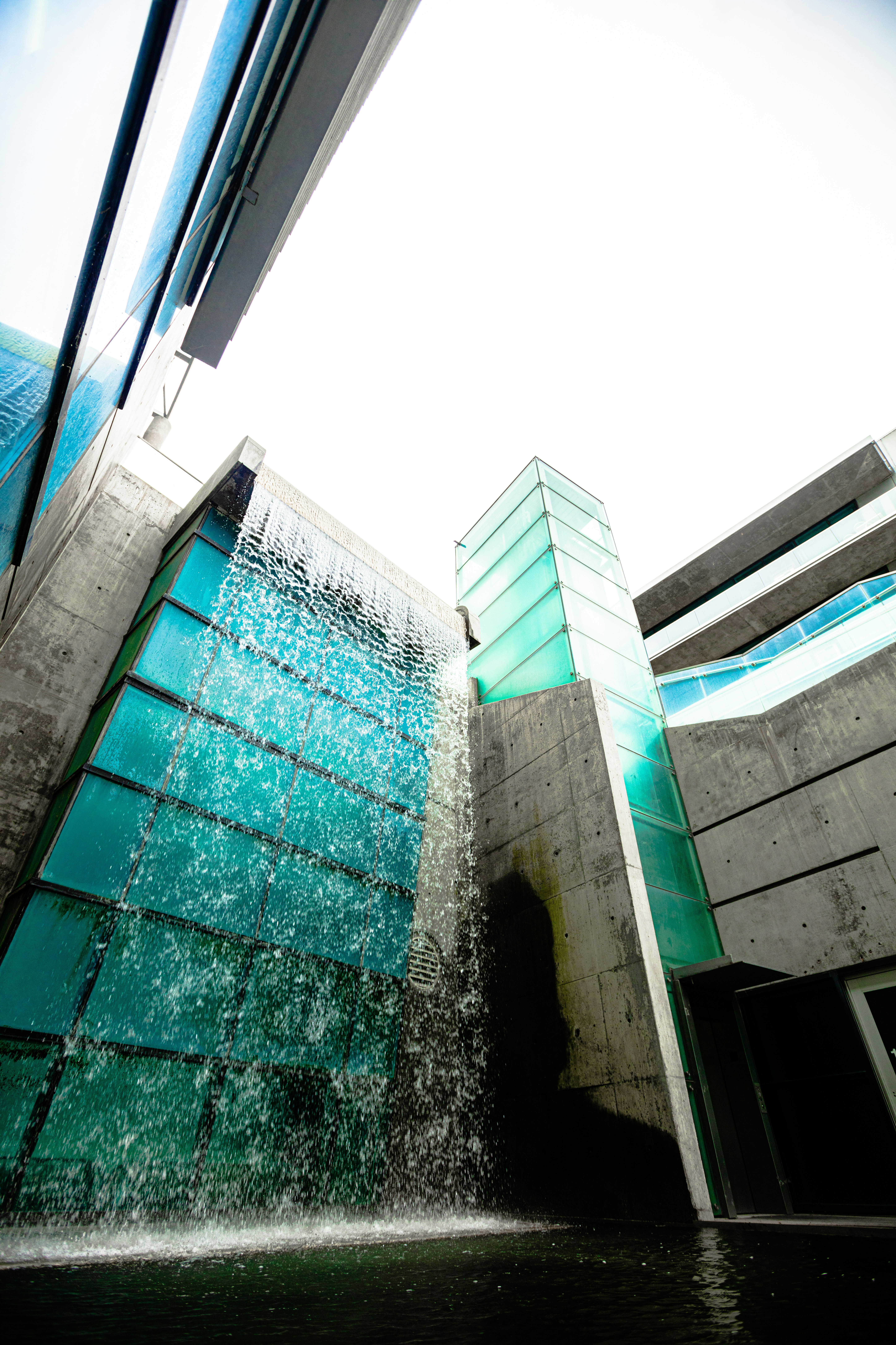 A building with a waterfall photo – Free Blue Image on Unsplash