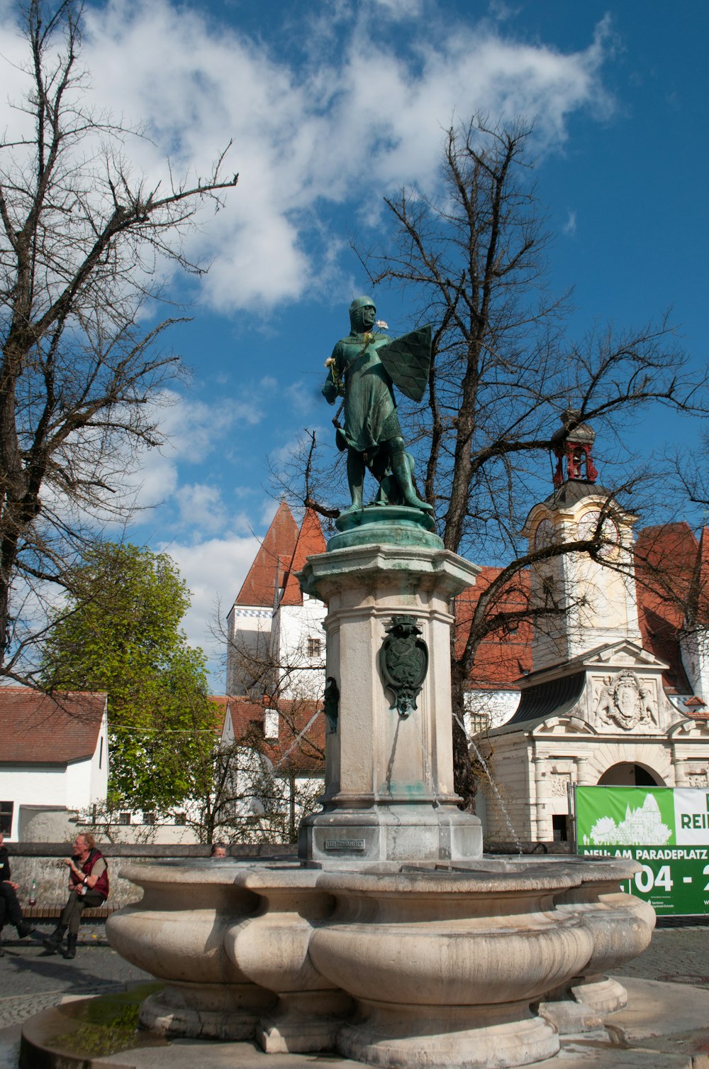 a statue of a person on a horse in a fountain