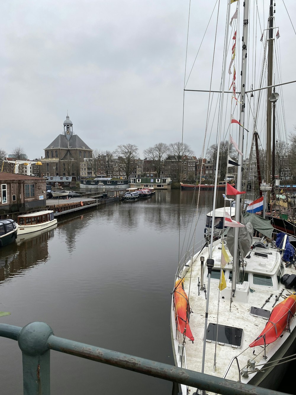 a group of boats sit in a harbor