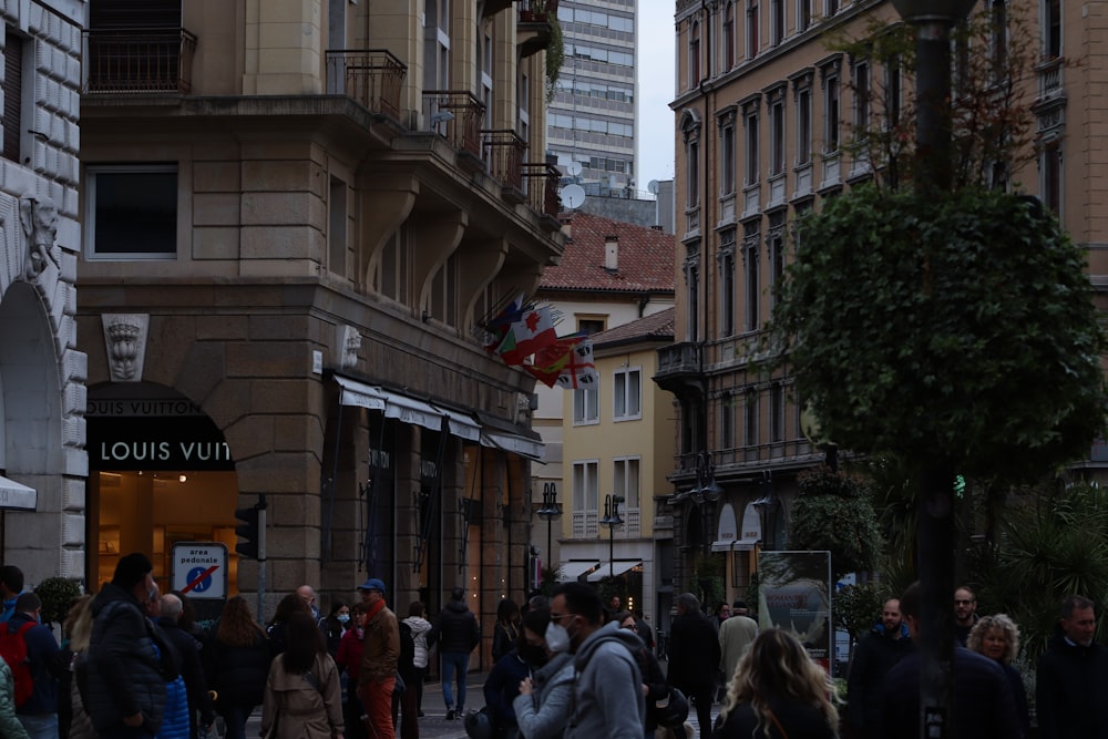 a crowd of people walking through a city