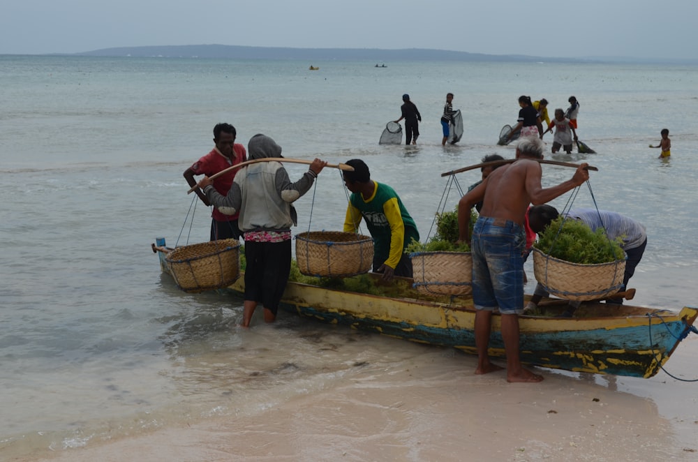 a group of people stand on a boat with baskets on it