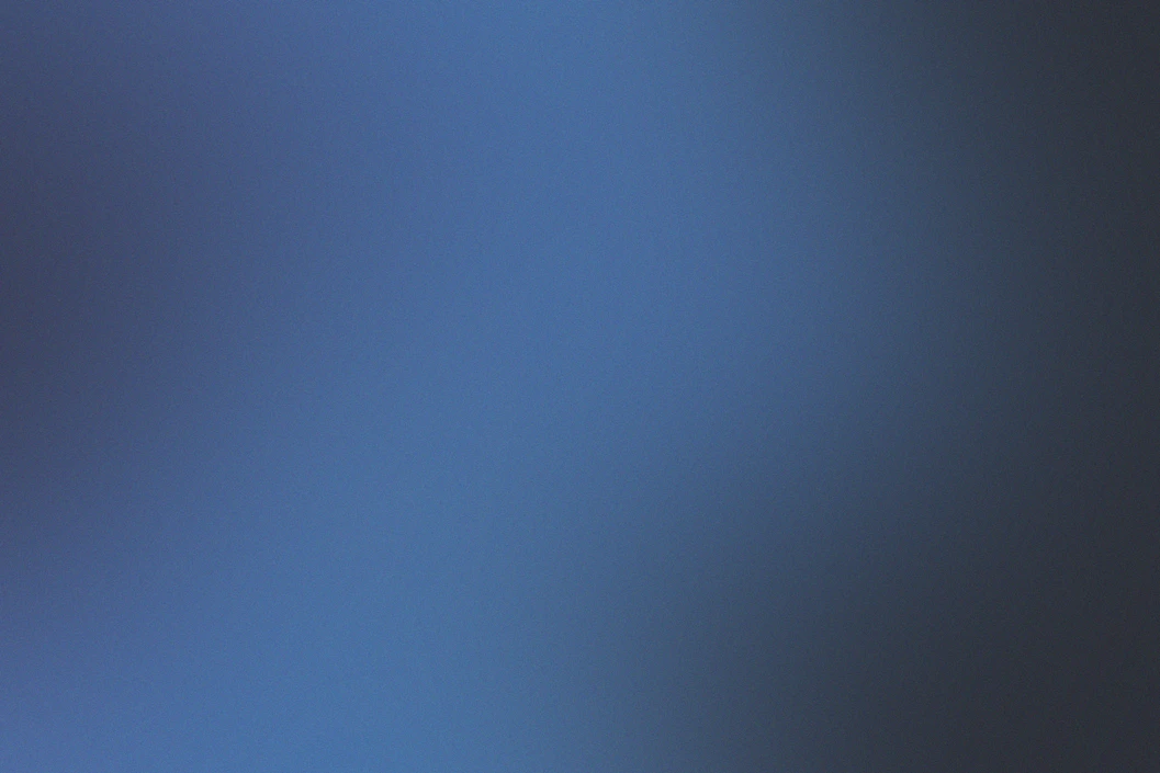 A smooth gradient shifting between deep blue and dark grey tones